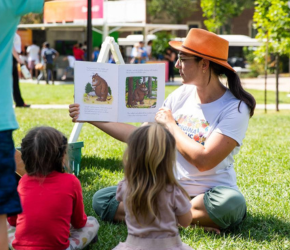 An RPL staff member reads a book to kids in Victoria Park.