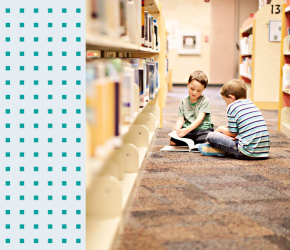 Two children enjoying their time at the library.