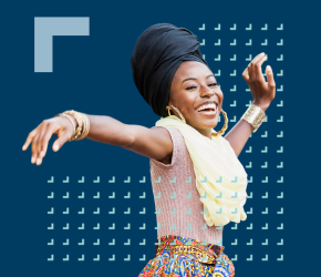 A smiling woman with a head covering, dances in celebration of Black History Month