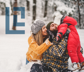 A family playing in the snow.