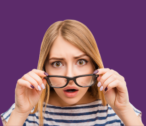 A woman peering over her glasses, surprised she hadn't heard that the library was fines free. 