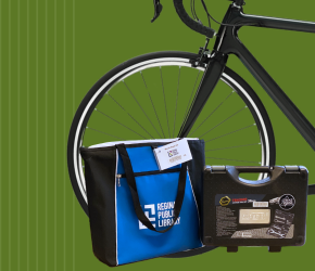 An RPL Bike Repair kit in front of a bicycle.