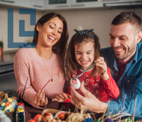 A family paints eggs together.