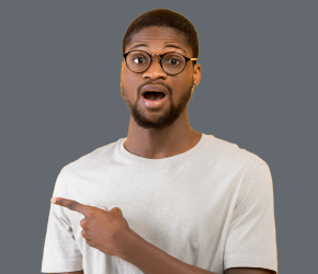 A man wearing glasses looks surprised.