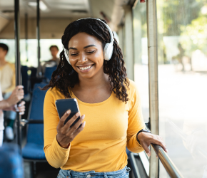 A woman listens to an audio book on the bus using the Libby App.