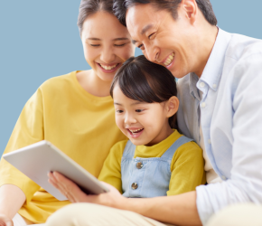 A mom and a dad explore the hoopla app with their child.