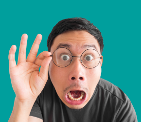 A surprised man holds his glasses. He can't believe the library has TWO art galleries!