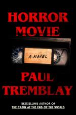 The cover of Horror Movie by Paul Tremblay. A cracked VHS tape against a black background.