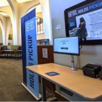 The RPL Holds Pick up table and check out computer at Archer Library at the University of Regina.