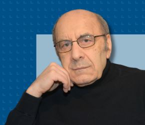 Author Michael Mirolla against a blue background.