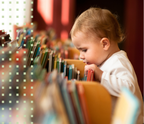 A small child sifting through library books.