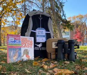 Birding backpack with birdwatching guides and binoculars