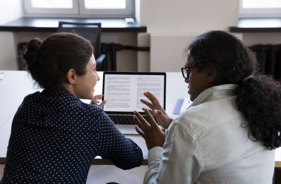 Two people looking over a document.